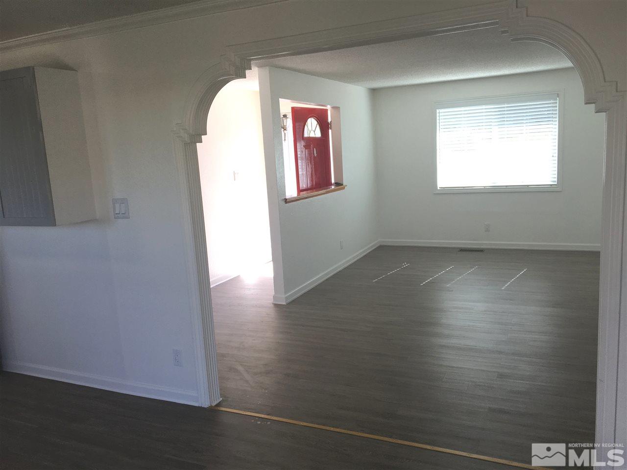 3951 West 7th Street Reno, NV 89503 - Photo 3 of 17 an empty room with wooden floor and windows