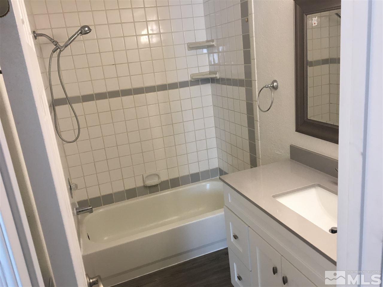 3951 West 7th Street Reno, NV 89503 - Photo 8 of 17 a bathroom with a bathtub and shower