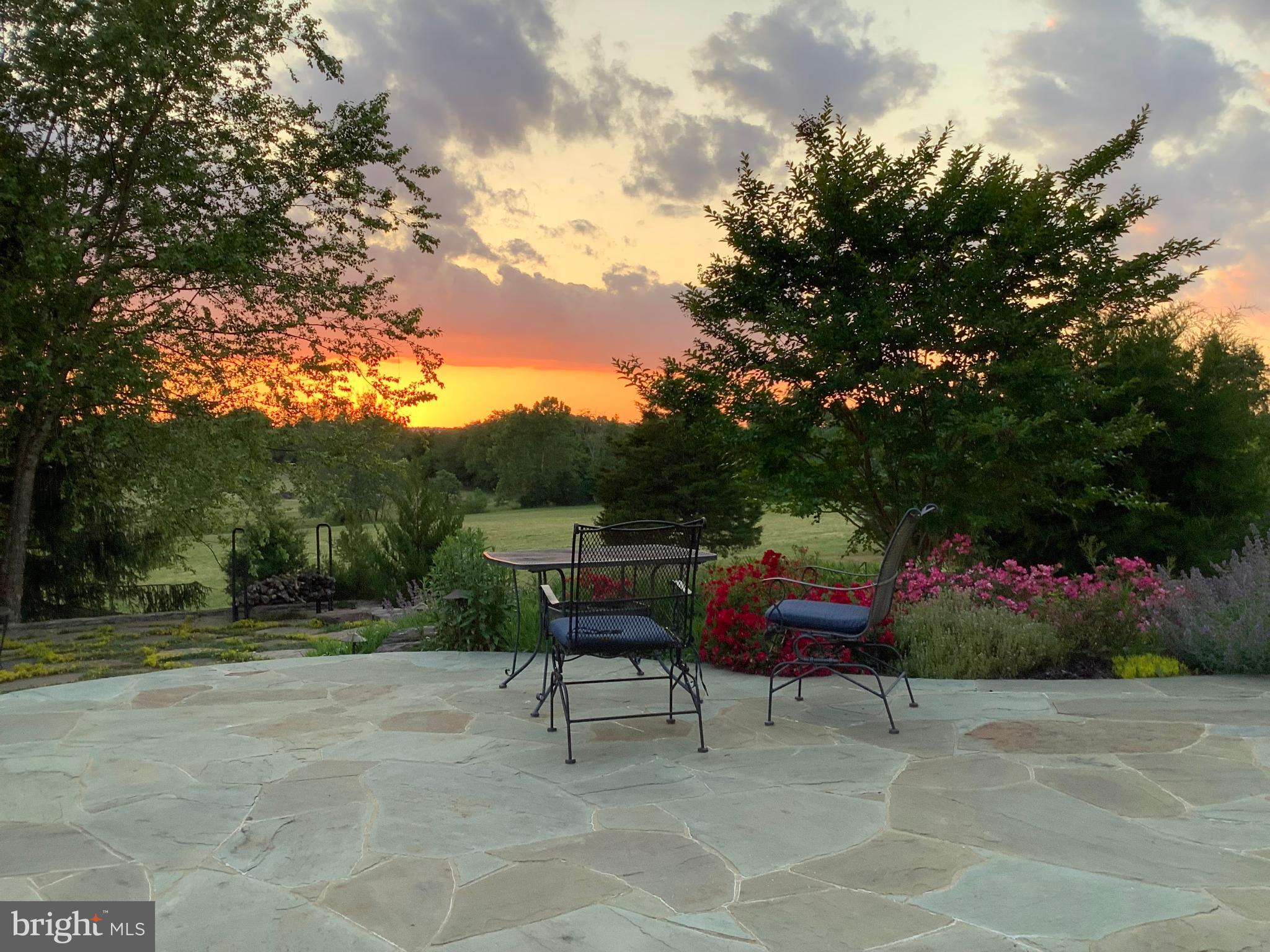 15371 Limestone School Road Leesburg, VA 20176 - Photo 9 of 54 Serene sunset over a tranquil garden.