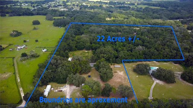 an aerial view of a houses with a swimming pool