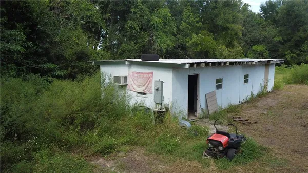 a backyard of a house with a yard and seating space