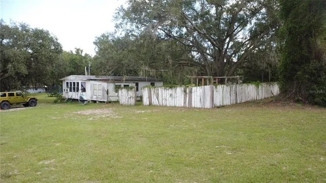 a view of a house with a yard and sitting area
