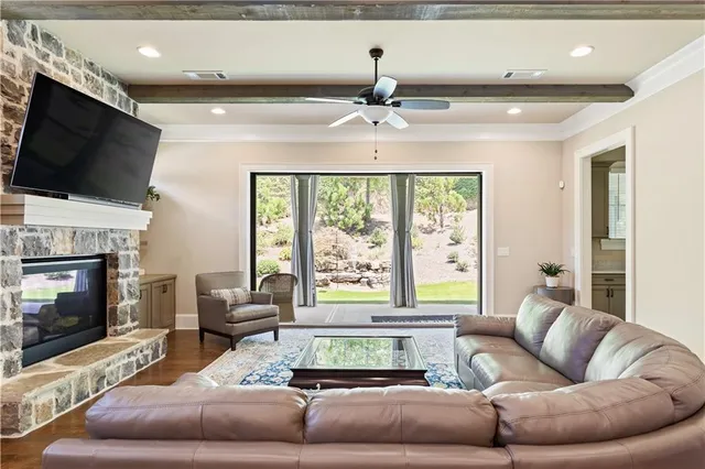 a living room with furniture a flat screen tv and a fireplace