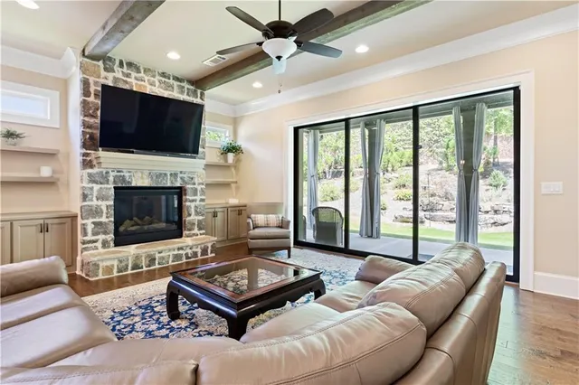 a living room with furniture fireplace and flat screen tv