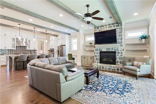 a living room with furniture a flat screen tv and a fireplace