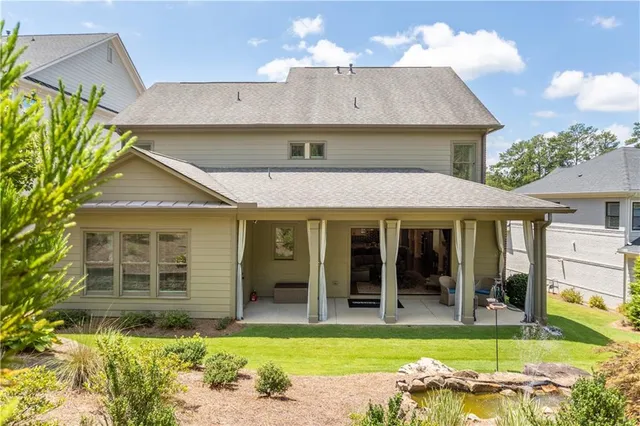 a view of a house with swimming pool and sitting area