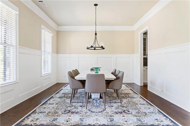 a dining room with furniture window and wooden floor