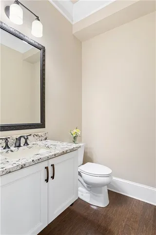 a bathroom with a granite countertop sink a toilet and a mirror