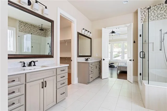 a bathroom with a double vanity sink mirror and bathtub