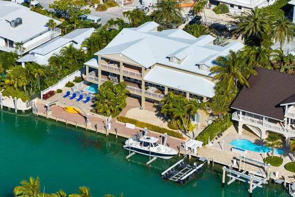an aerial view of a house with a garden and swimming pool