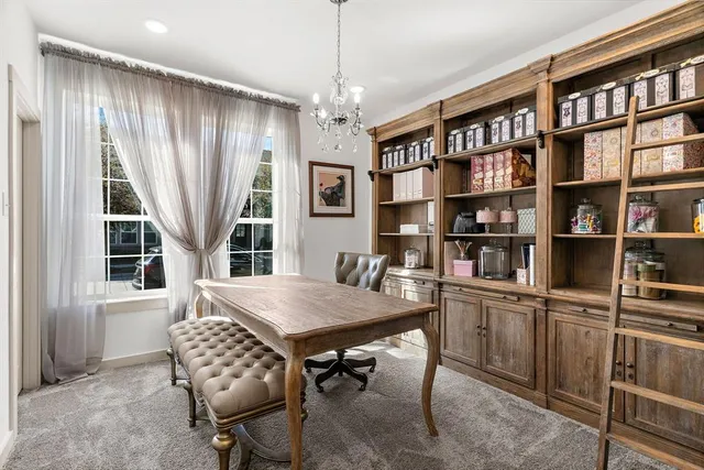 a view of a livingroom with furniture and a book shelf