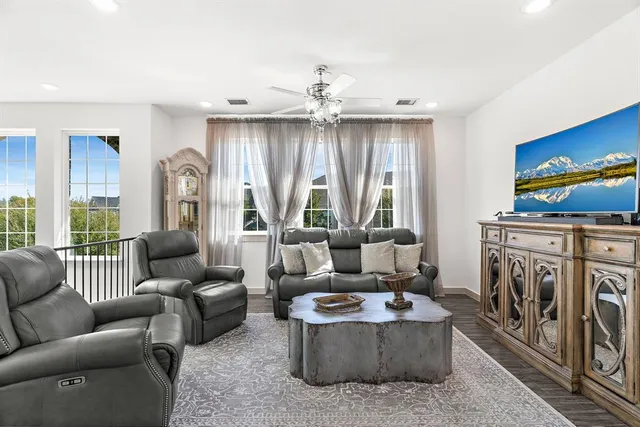 a living room with furniture a fireplace and a large window