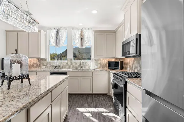 a kitchen with a stove and cabinets