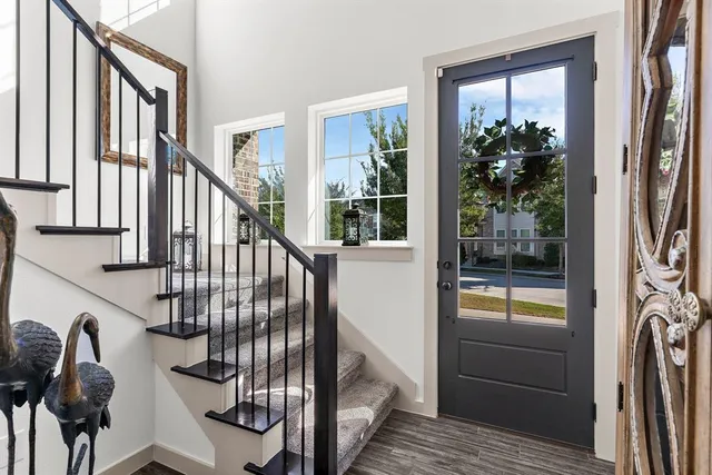 a view of staircase with lots of wooden floor and door