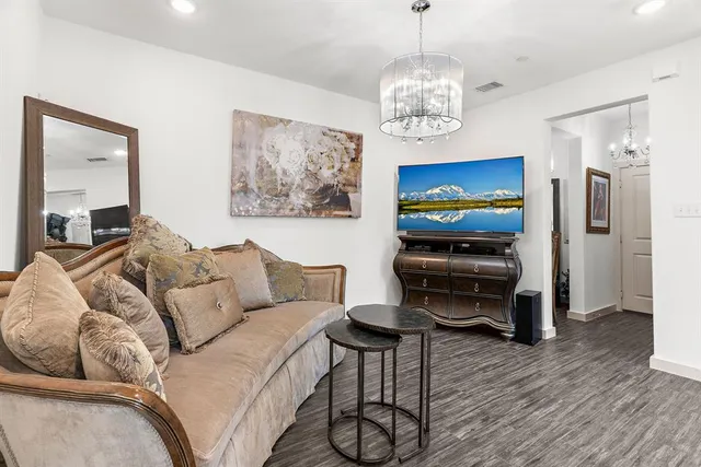 a living room with furniture a rug and a flat screen tv