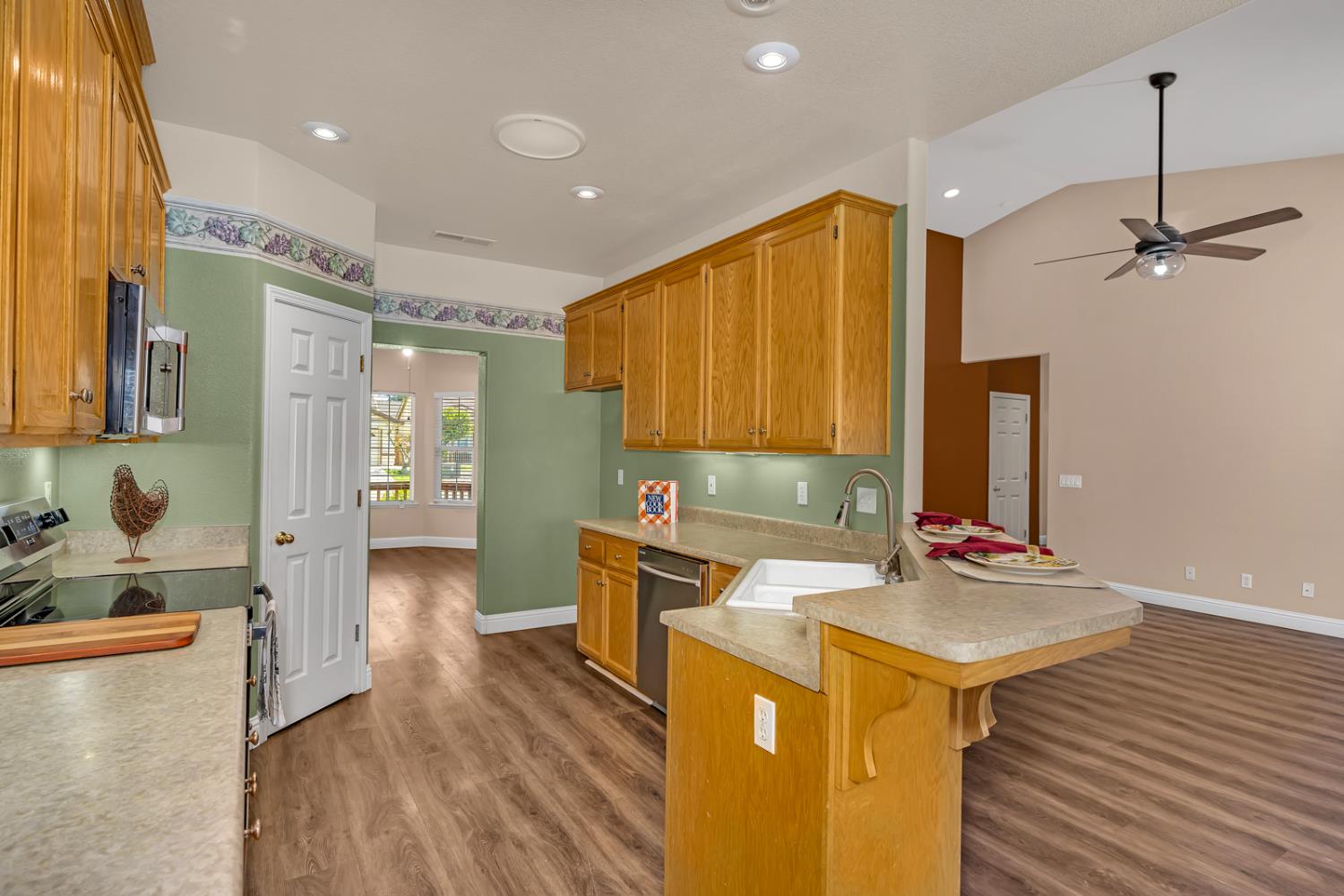 3877 Pintail Court Merced, CA 95340 - Photo 11 of 42 a kitchen with a sink appliances and cabinets