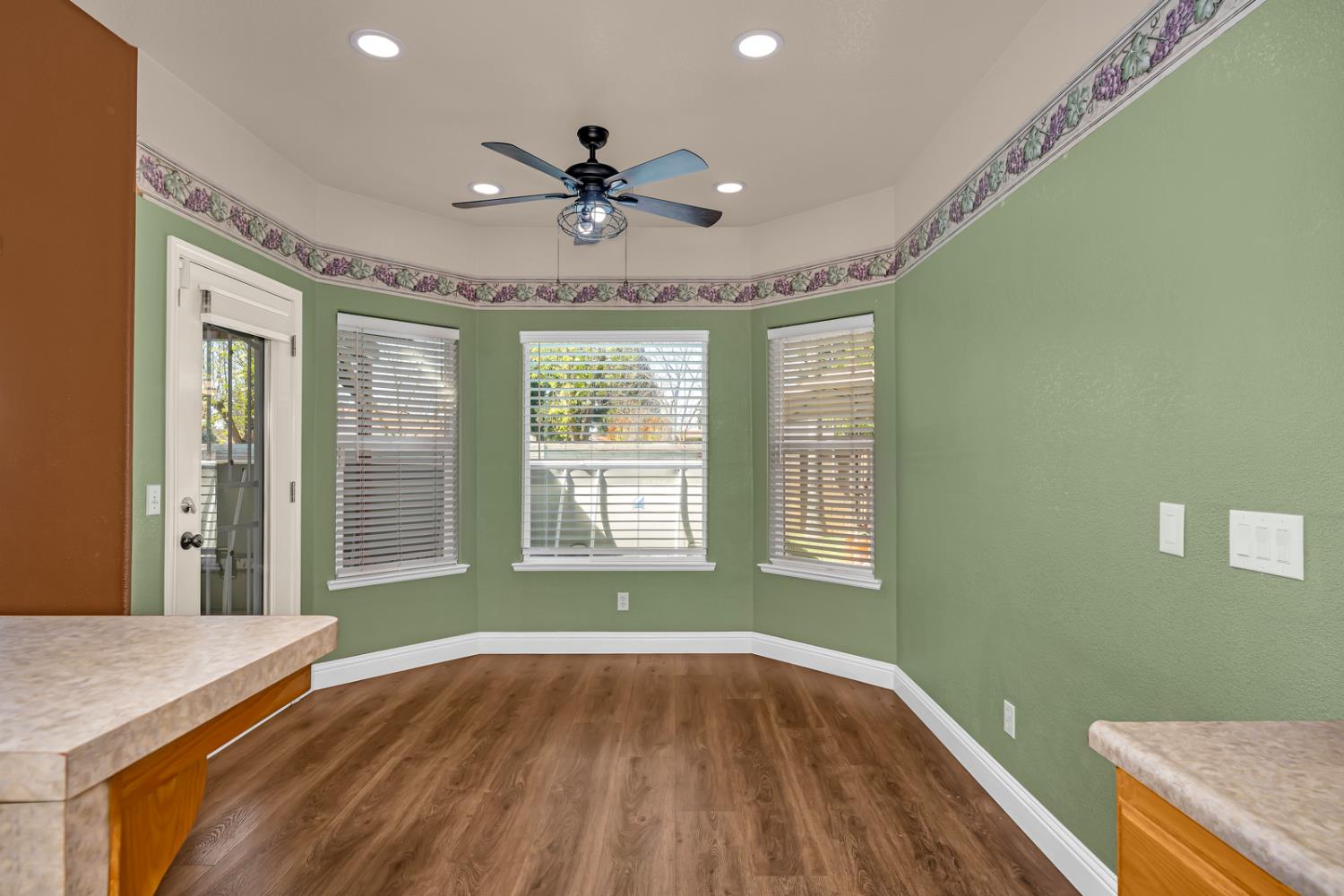 3877 Pintail Court Merced, CA 95340 - Photo 12 of 42 a view of an empty room with a window and wooden floor
