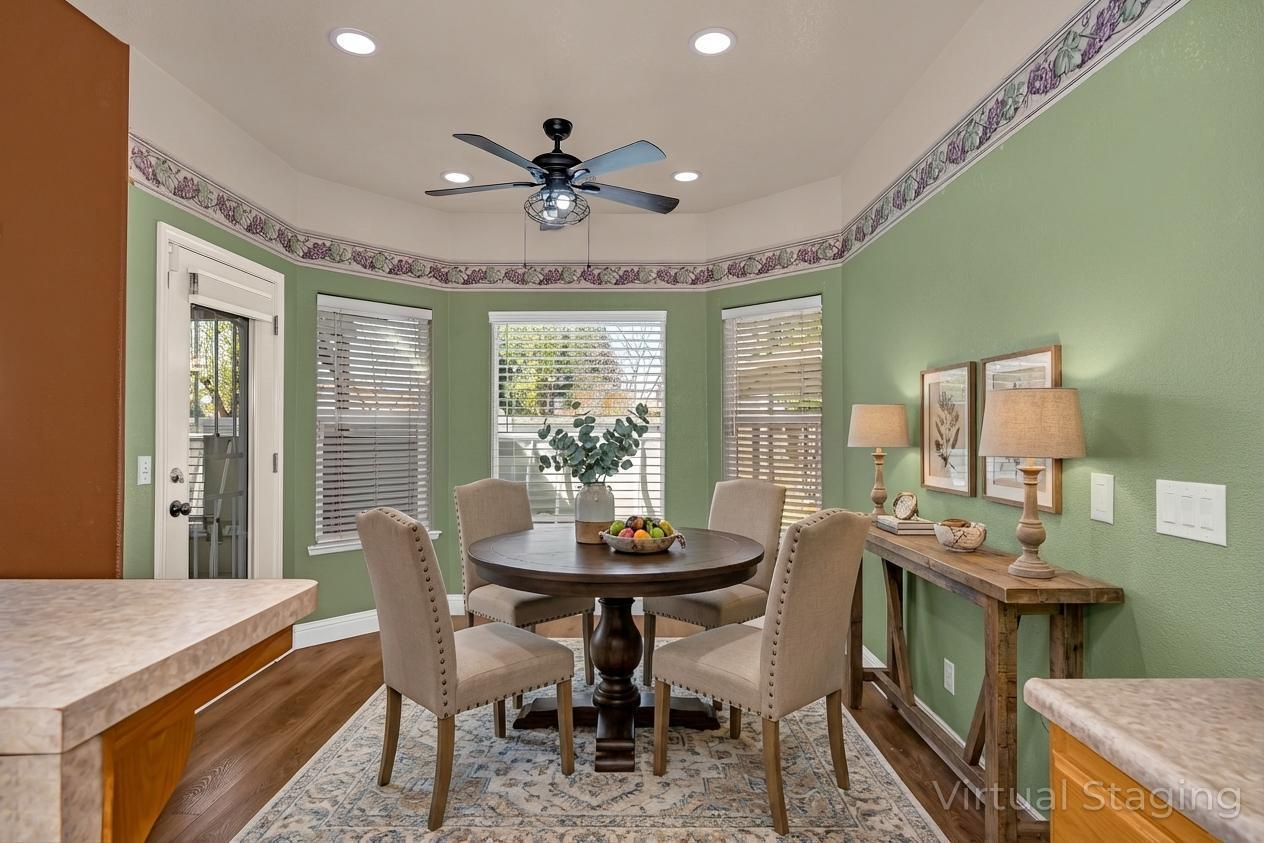 3877 Pintail Court Merced, CA 95340 - Photo 13 of 42 a dining room with furniture a chandelier and wooden floor