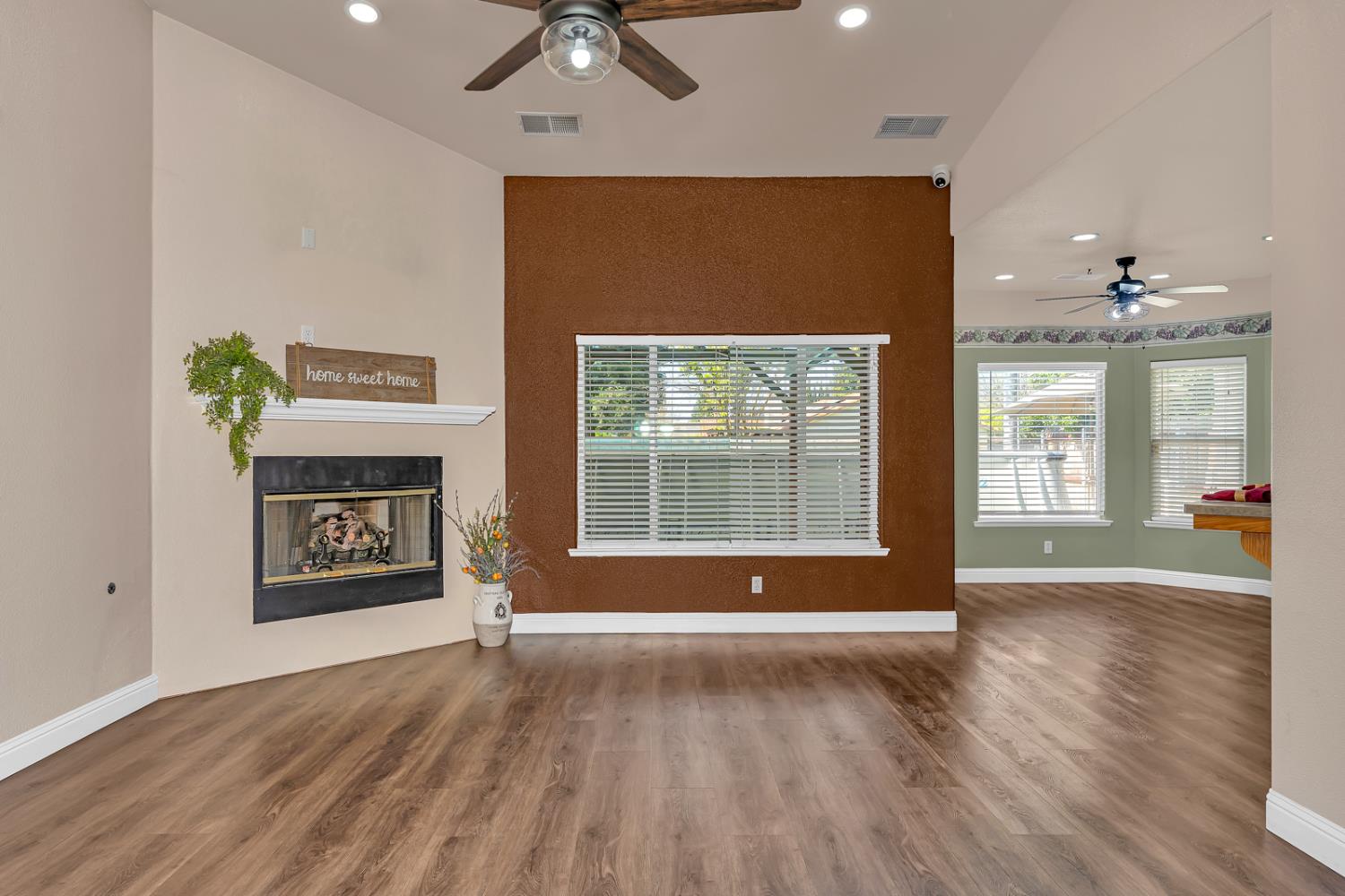 3877 Pintail Court Merced, CA 95340 - Photo 17 of 42 a view of an empty room with a window and wooden floor