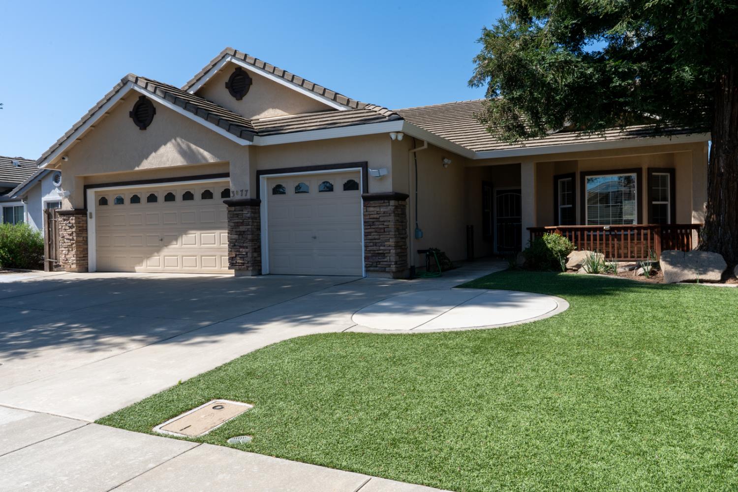 3877 Pintail Court Merced, CA 95340 - Photo 2 of 42 a front view of a house with a yard and garage