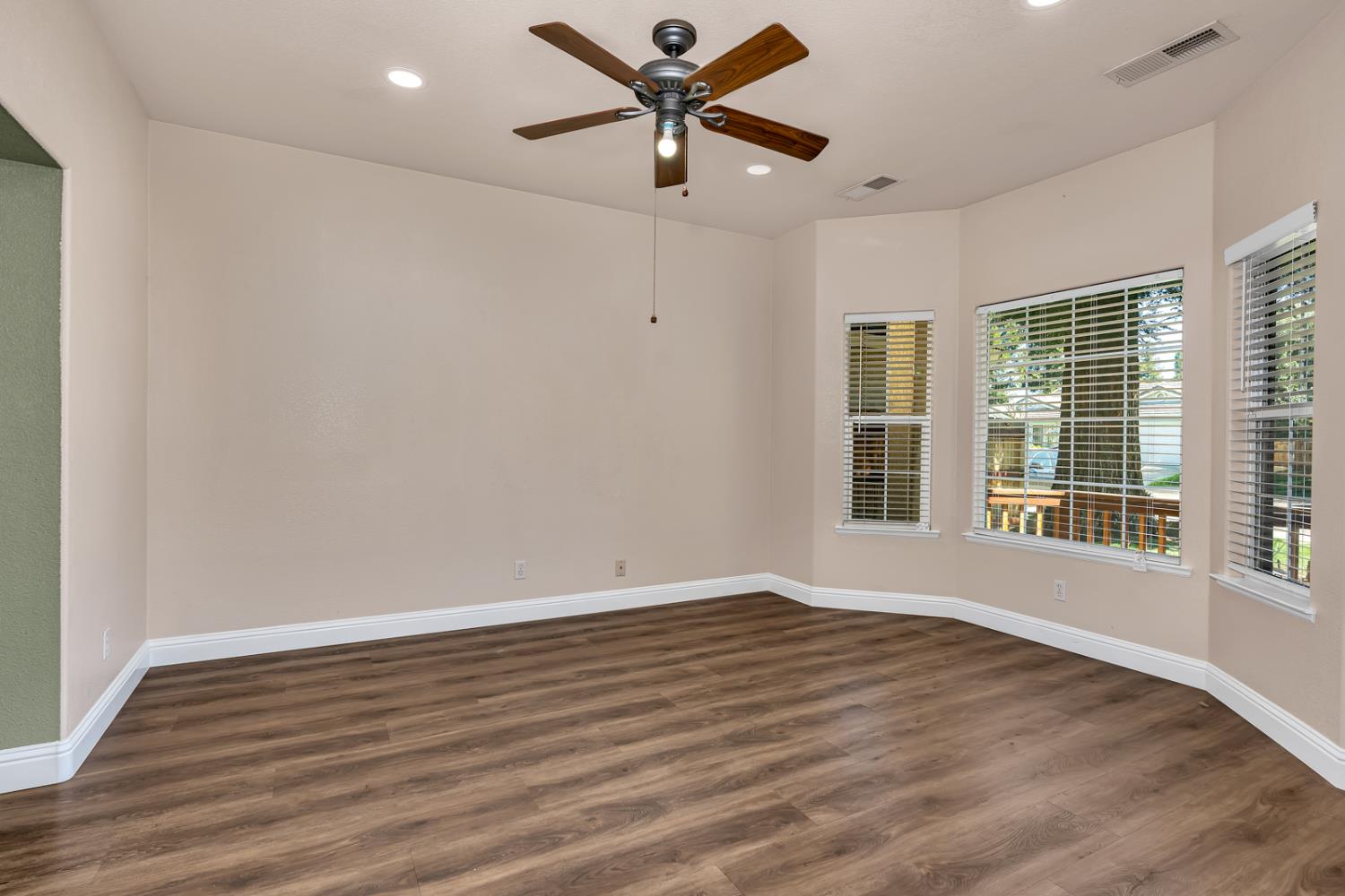 3877 Pintail Court Merced, CA 95340 - Photo 21 of 42 wooden floor in an empty room with a window