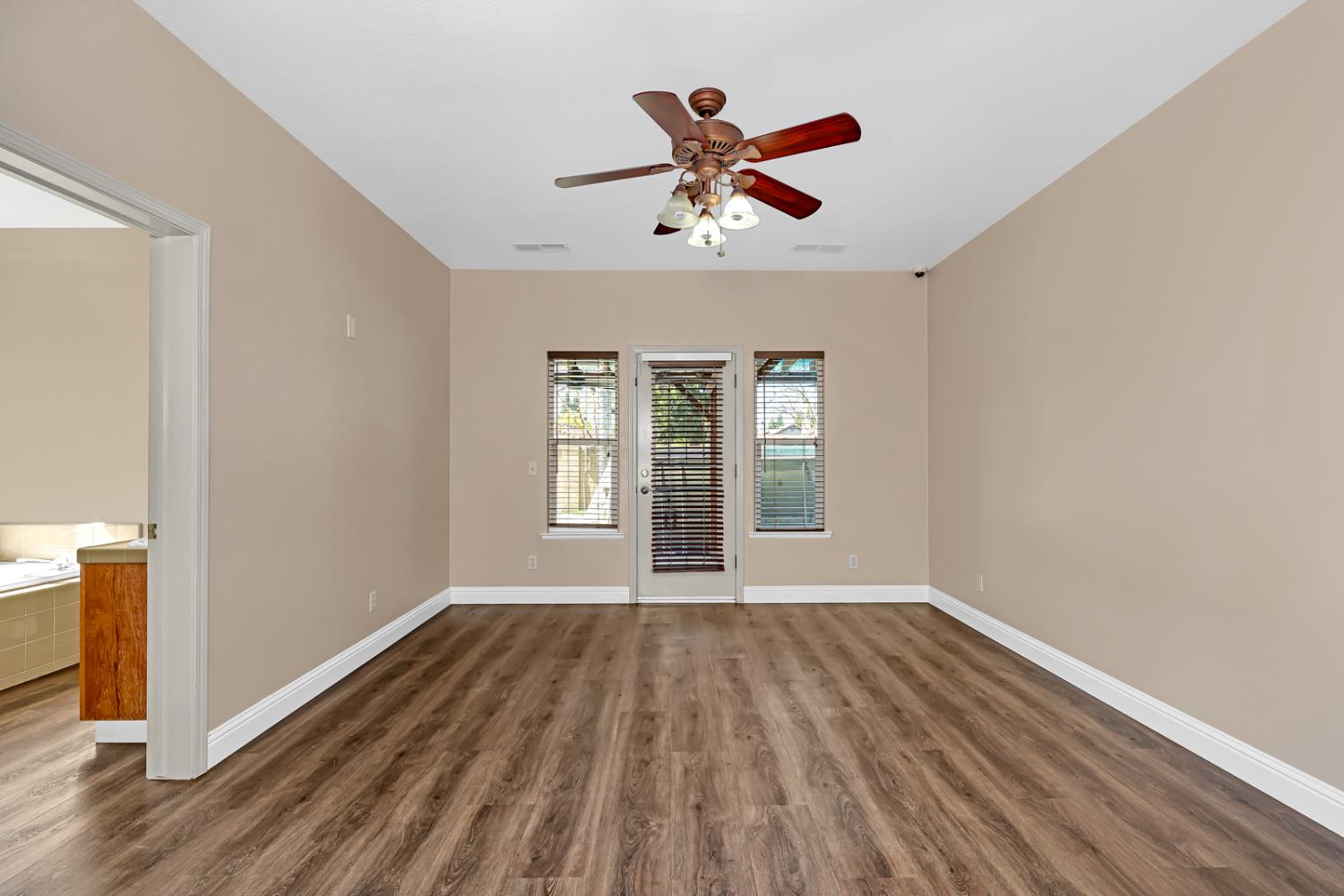 3877 Pintail Court Merced, CA 95340 - Photo 22 of 42 a view of empty room with wooden floor and fan