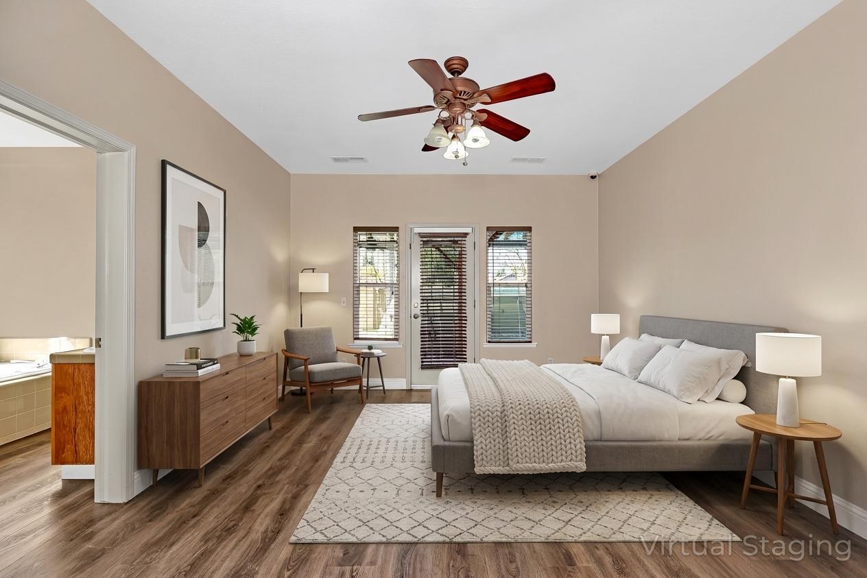 3877 Pintail Court Merced, CA 95340 - Photo 23 of 42 a bedroom with a large bed and a chandelier