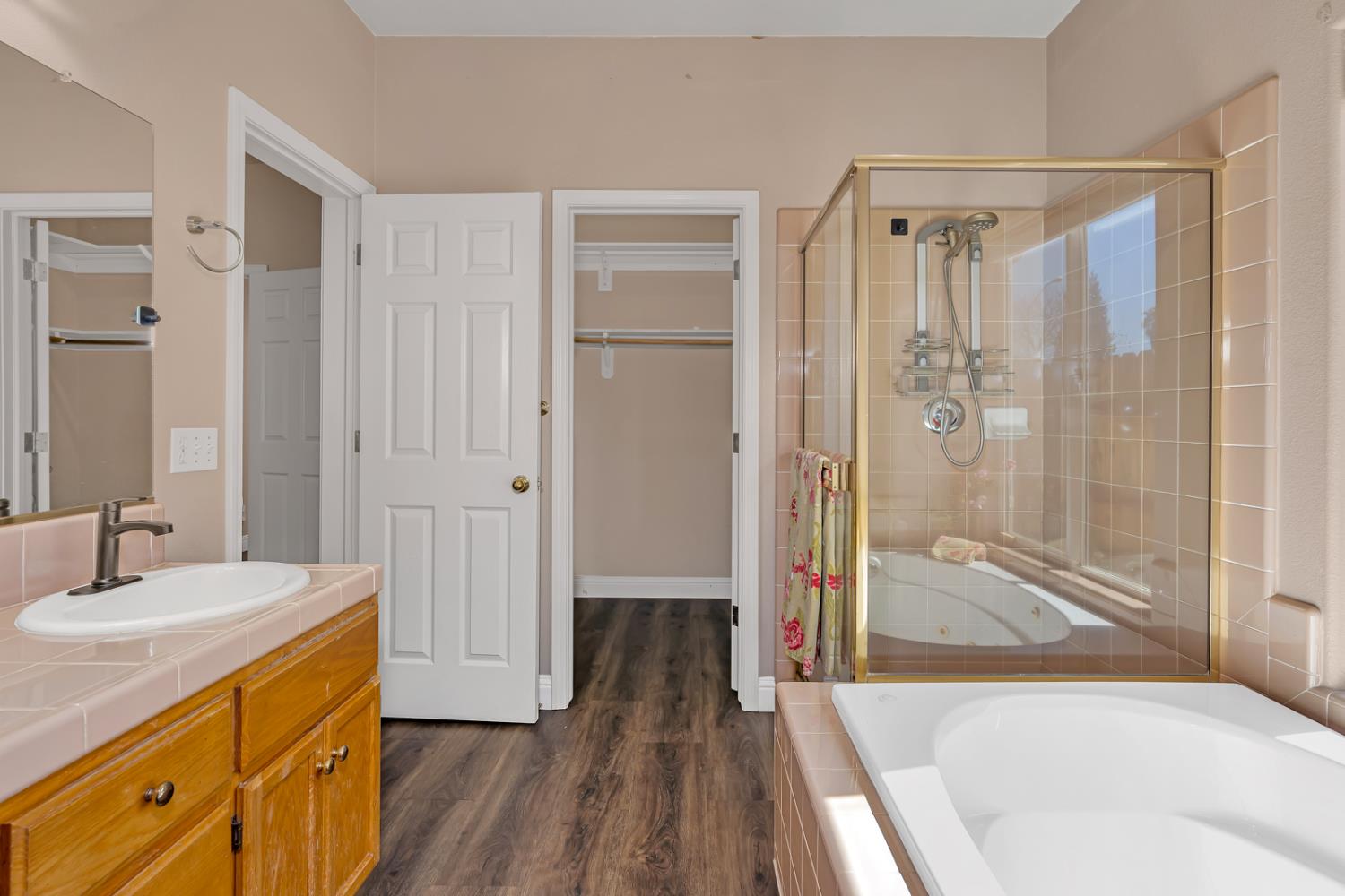 3877 Pintail Court Merced, CA 95340 - Photo 28 of 42 a bathroom with a tub shower vanity and a sink