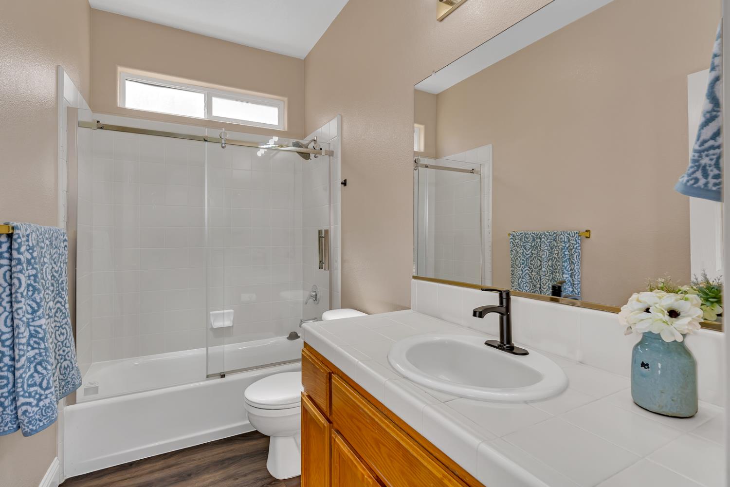 3877 Pintail Court Merced, CA 95340 - Photo 31 of 42 a bathroom with a sink a toilet and shower