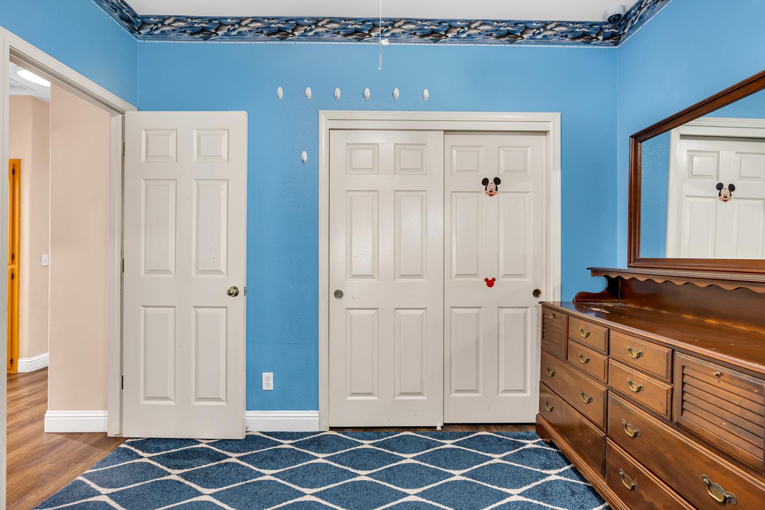 3877 Pintail Court Merced, CA 95340 - Photo 35 of 42 an empty room with wooden floor and cabinet