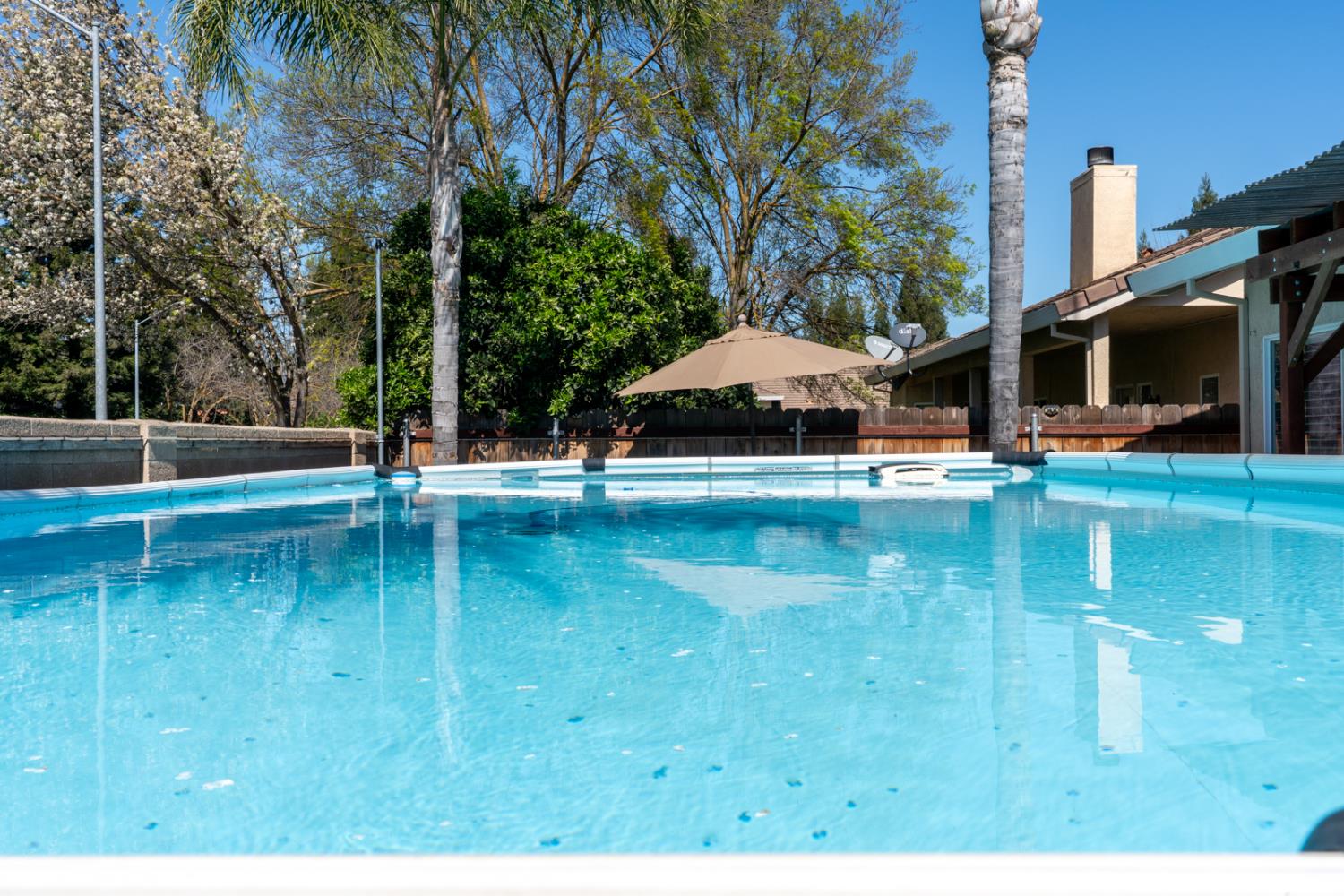 3877 Pintail Court Merced, CA 95340 - Photo 38 of 42 a swimming pool with yard in front of it