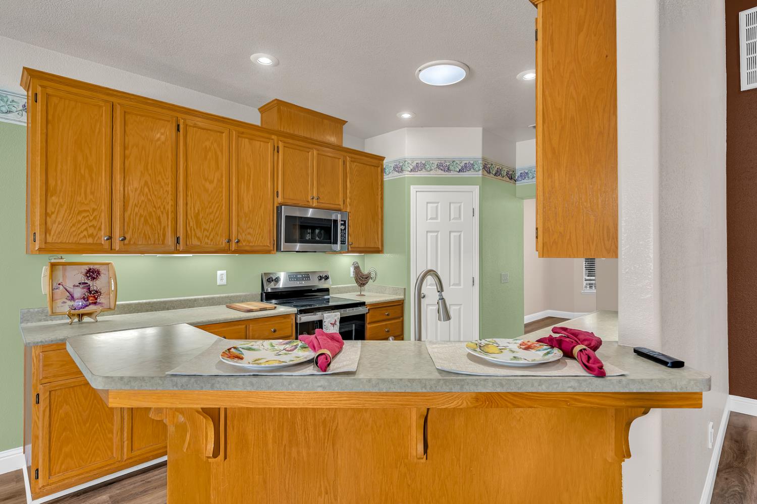 3877 Pintail Court Merced, CA 95340 - Photo 10 of 42 a kitchen with a sink a stove and a microwave