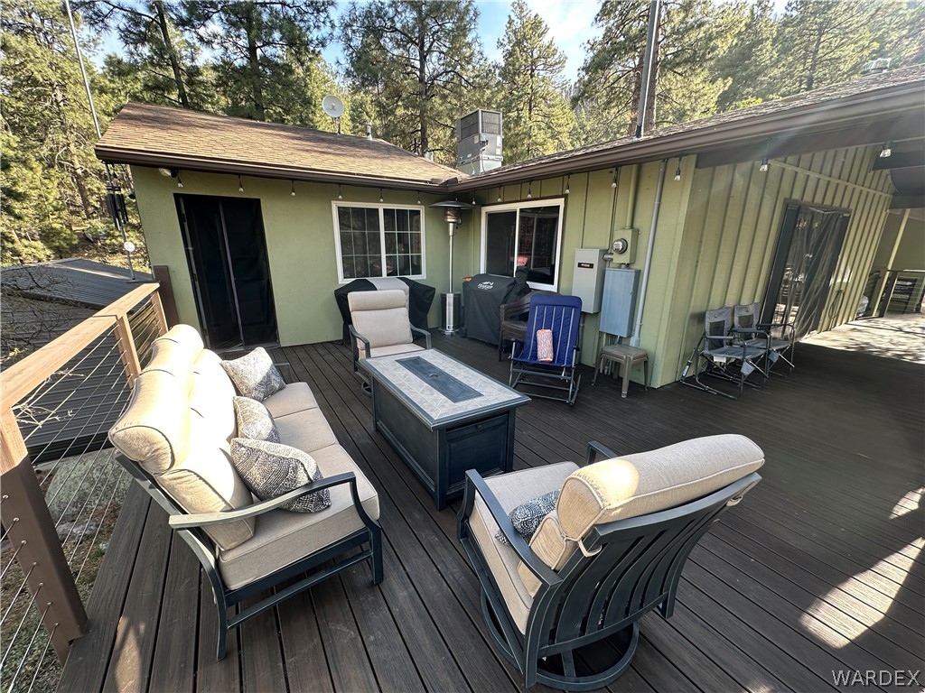 6615 Flag Mine Road Kingman, AZ 86401 - Photo 58 of 72 a view of a patio with couches chairs and a wooden floor