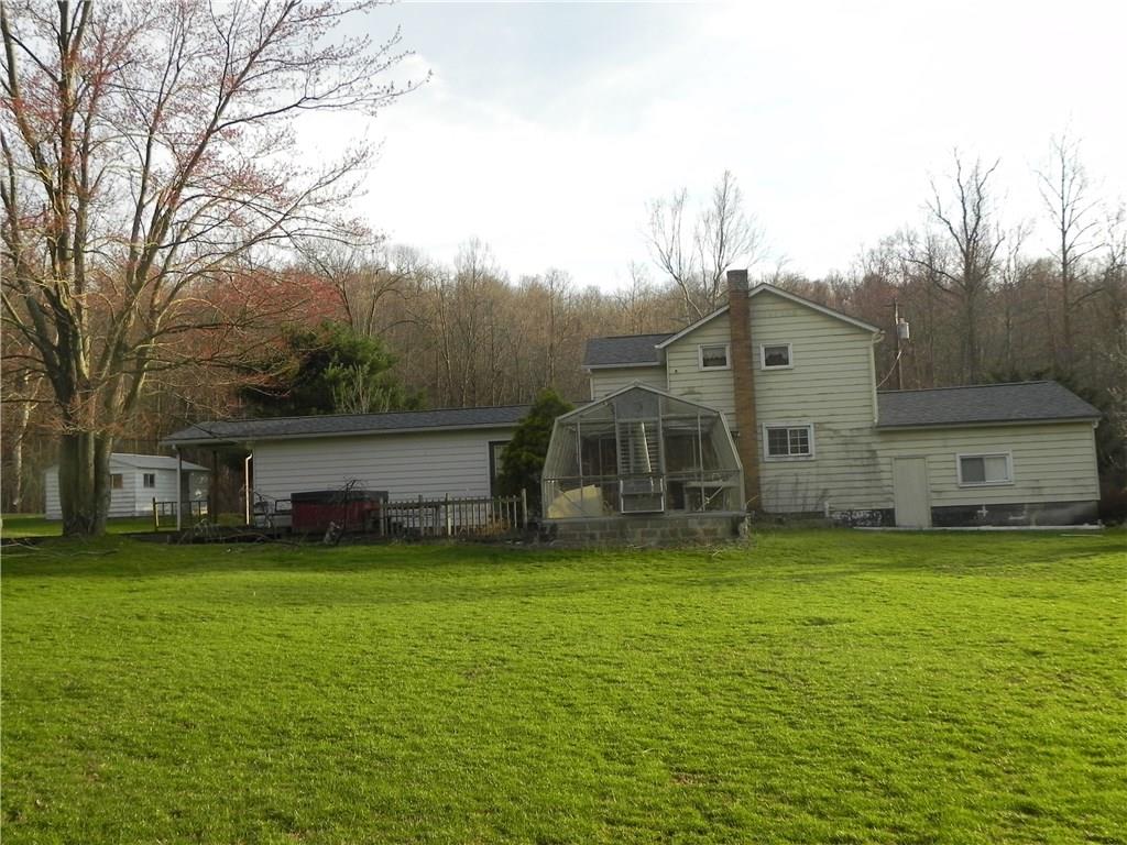 1267 Millwood Road Derry, PA 15627 - Photo 12 of 17 Backside of the house shows the greenhouse. A little TLC here and you'll have this filled to the britches with plants!