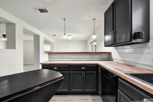 a kitchen with a sink and cabinets
