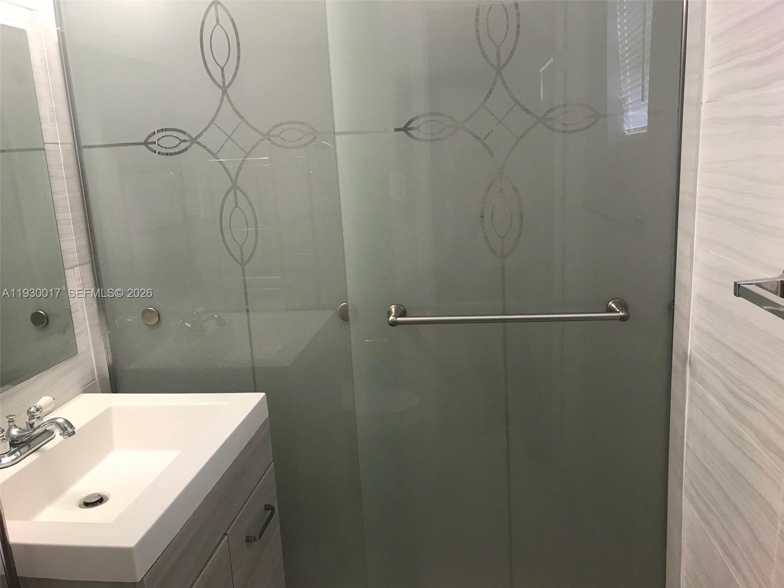 4550 Southwest 67th Avenue, Unit 7 Miami, FL 33155 - Photo 11 of 25 a bathroom with a sink a shower and vanity