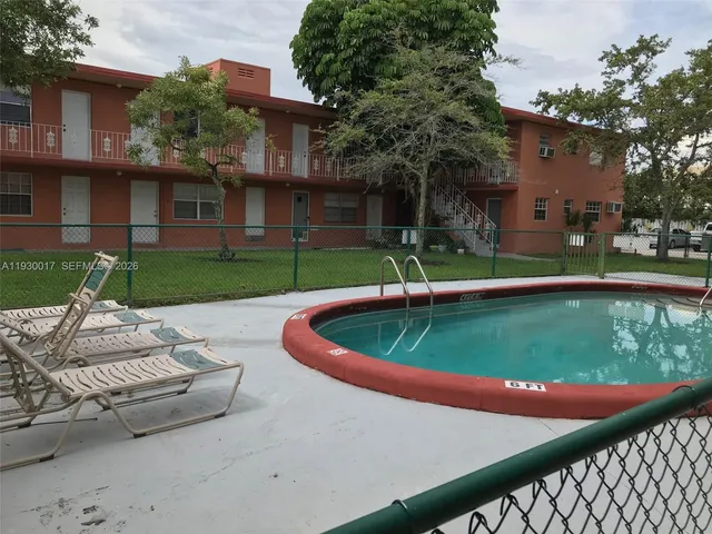a swimming pool with outdoor seating and yard