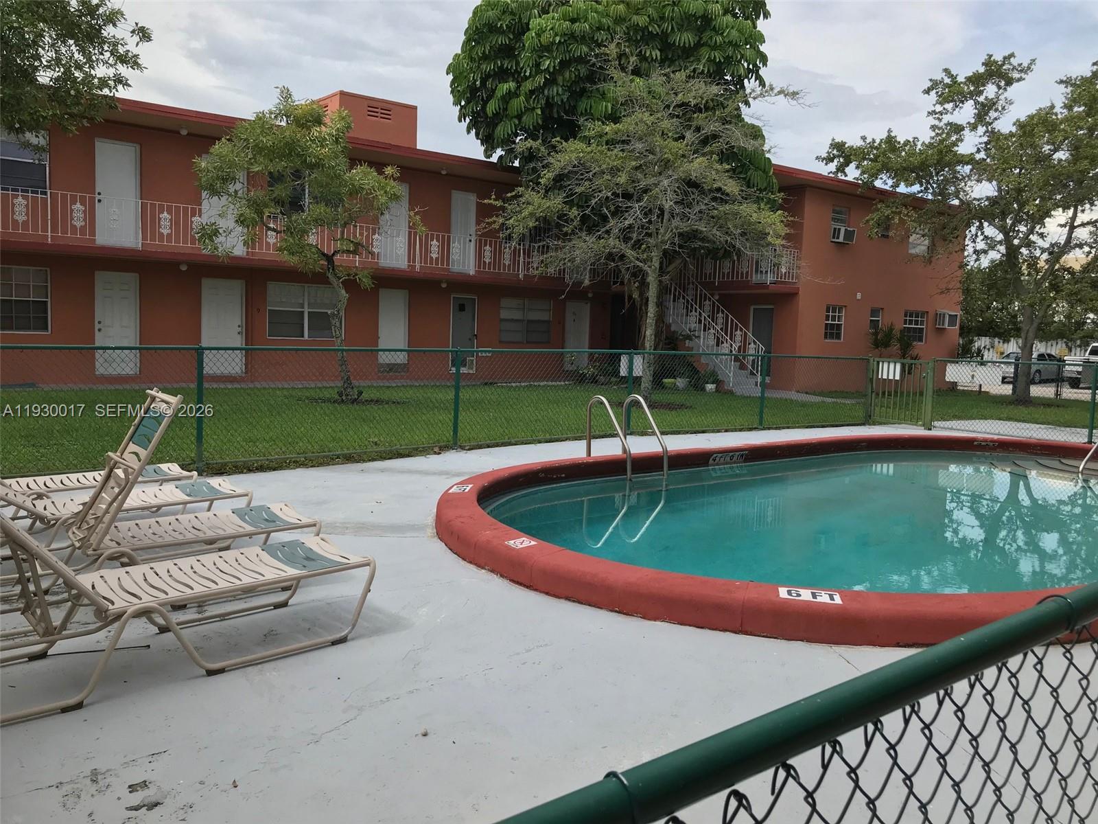 4550 Southwest 67th Avenue, Unit 7 Miami, FL 33155 - Photo 12 of 25 a front view of a house with a yard table and chairs