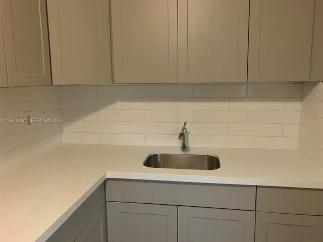 a bathroom with a sink and mirror
