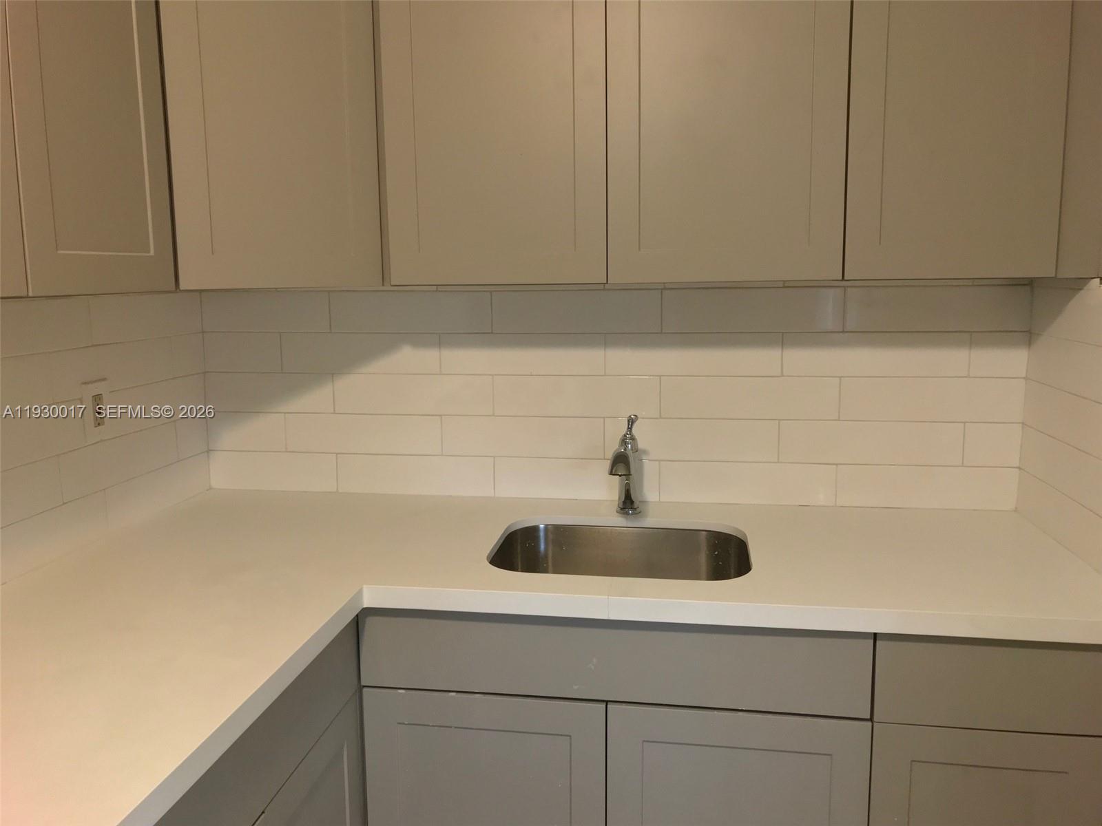 4550 Southwest 67th Avenue, Unit 7 Miami, FL 33155 - Photo 18 of 25 a kitchen with a sink and cabinets