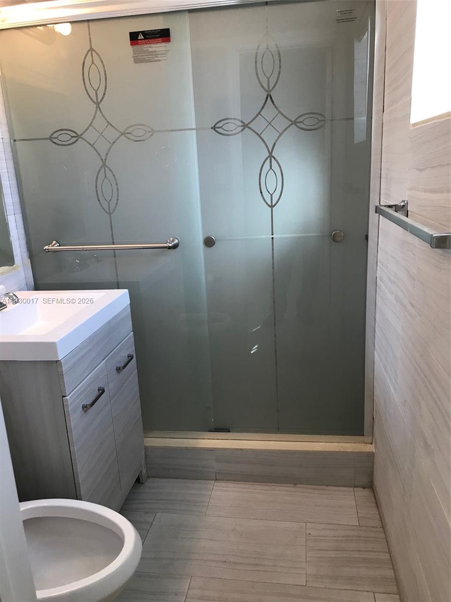 4550 Southwest 67th Avenue, Unit 7 Miami, FL 33155 - Photo 19 of 25 a bathroom with a sink and mirror