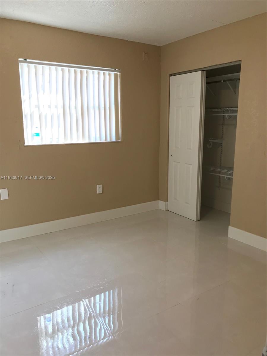4550 Southwest 67th Avenue, Unit 7 Miami, FL 33155 - Photo 20 of 25 an empty room with windows