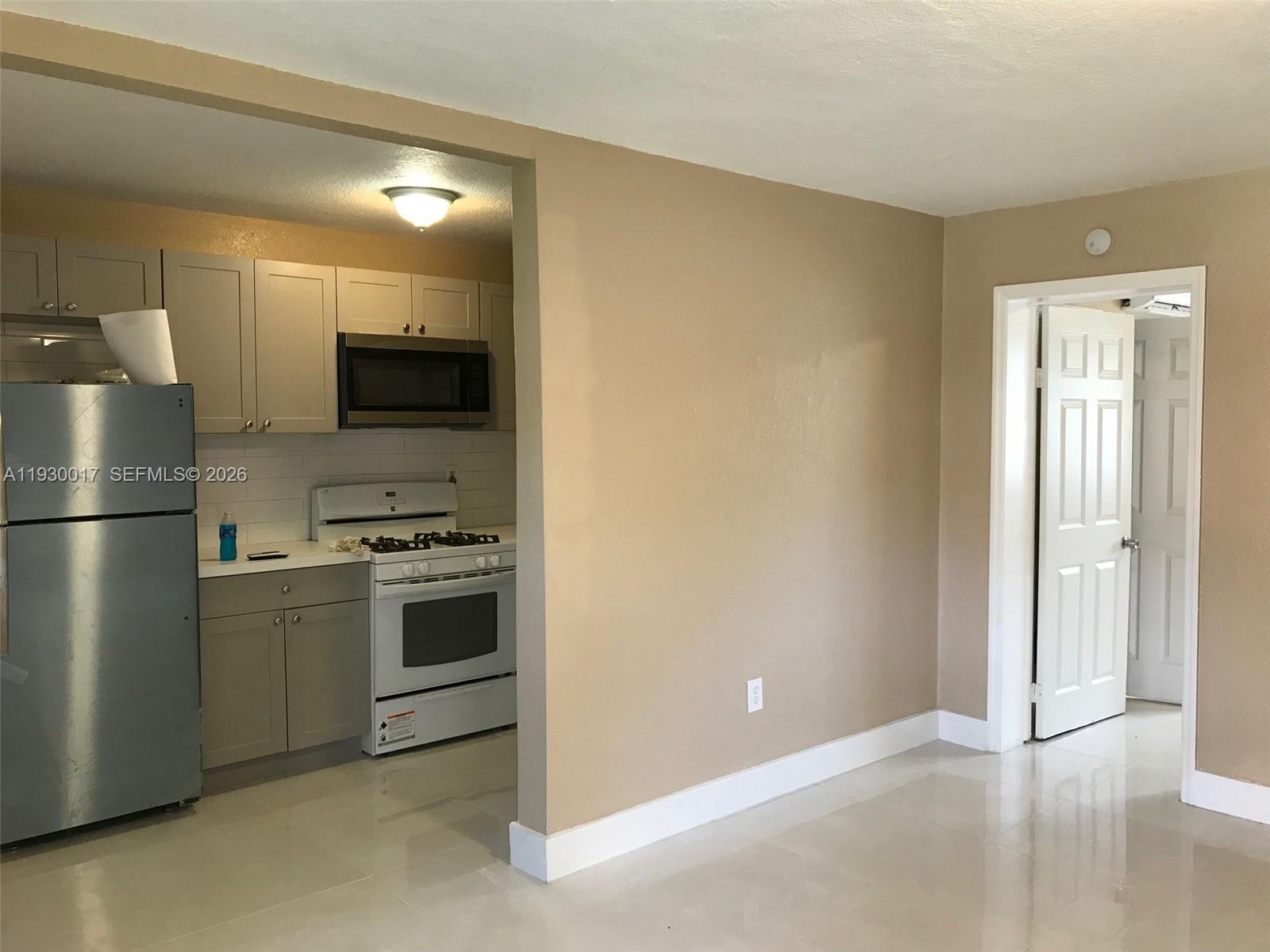 4550 Southwest 67th Avenue, Unit 7 Miami, FL 33155 - Photo 22 of 25 a kitchen with cabinets and stainless steel appliances