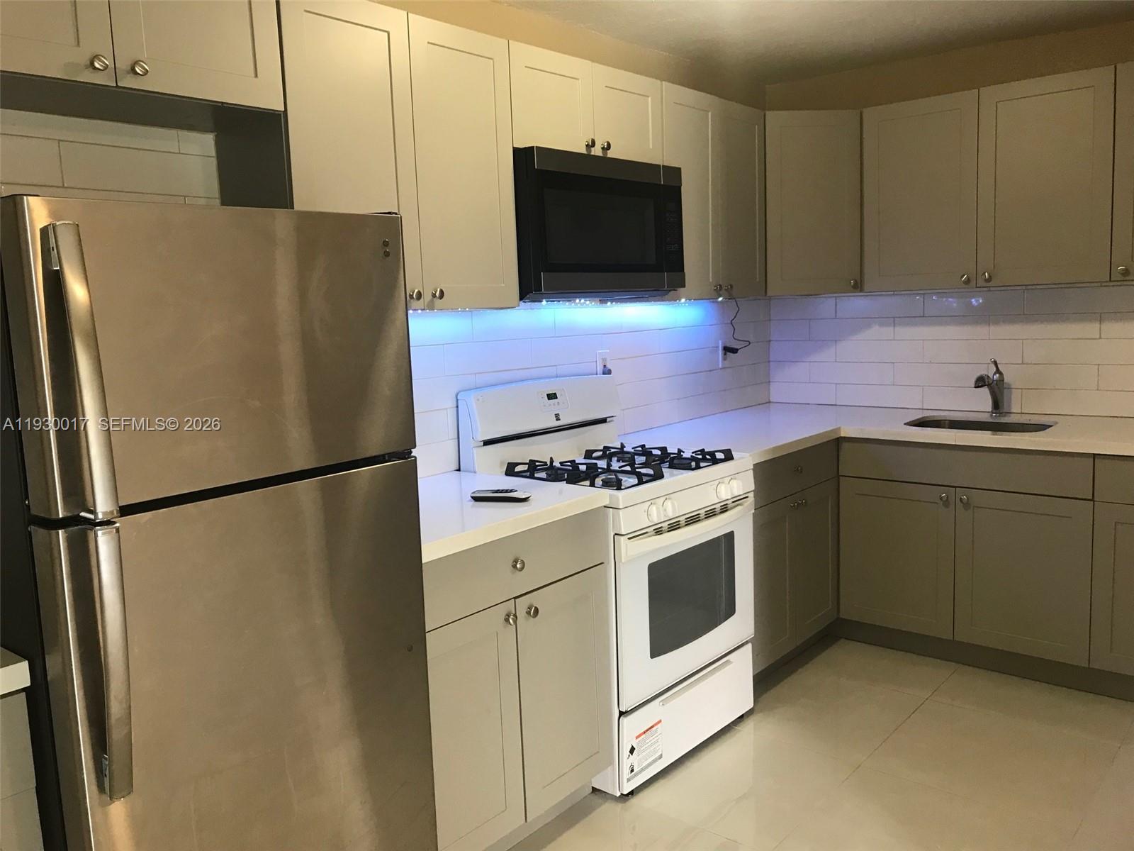 4550 Southwest 67th Avenue, Unit 7 Miami, FL 33155 - Photo 3 of 25 a kitchen with stainless steel appliances a refrigerator stove and microwave