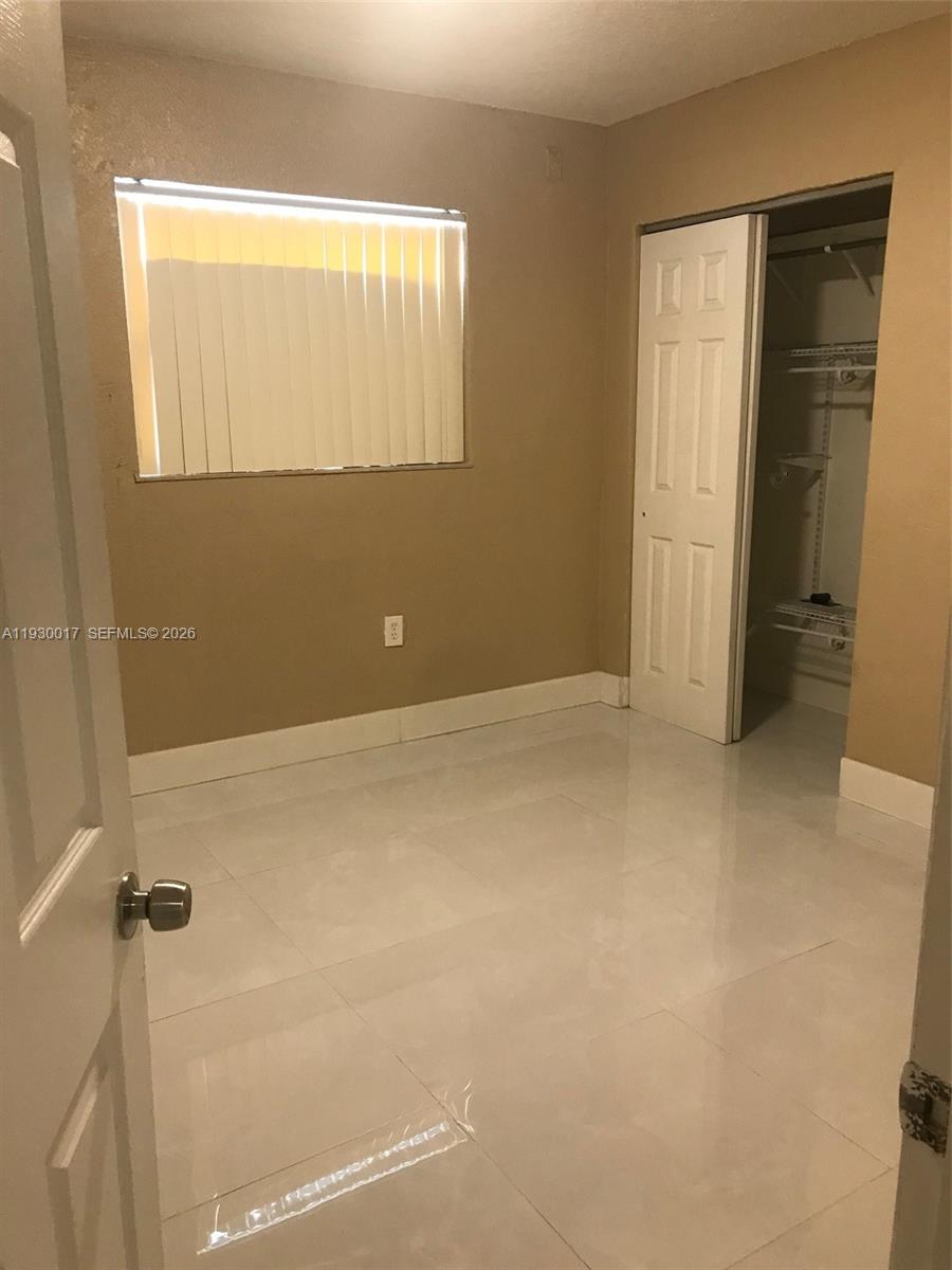 4550 Southwest 67th Avenue, Unit 7 Miami, FL 33155 - Photo 5 of 25 a view of an empty room with a window