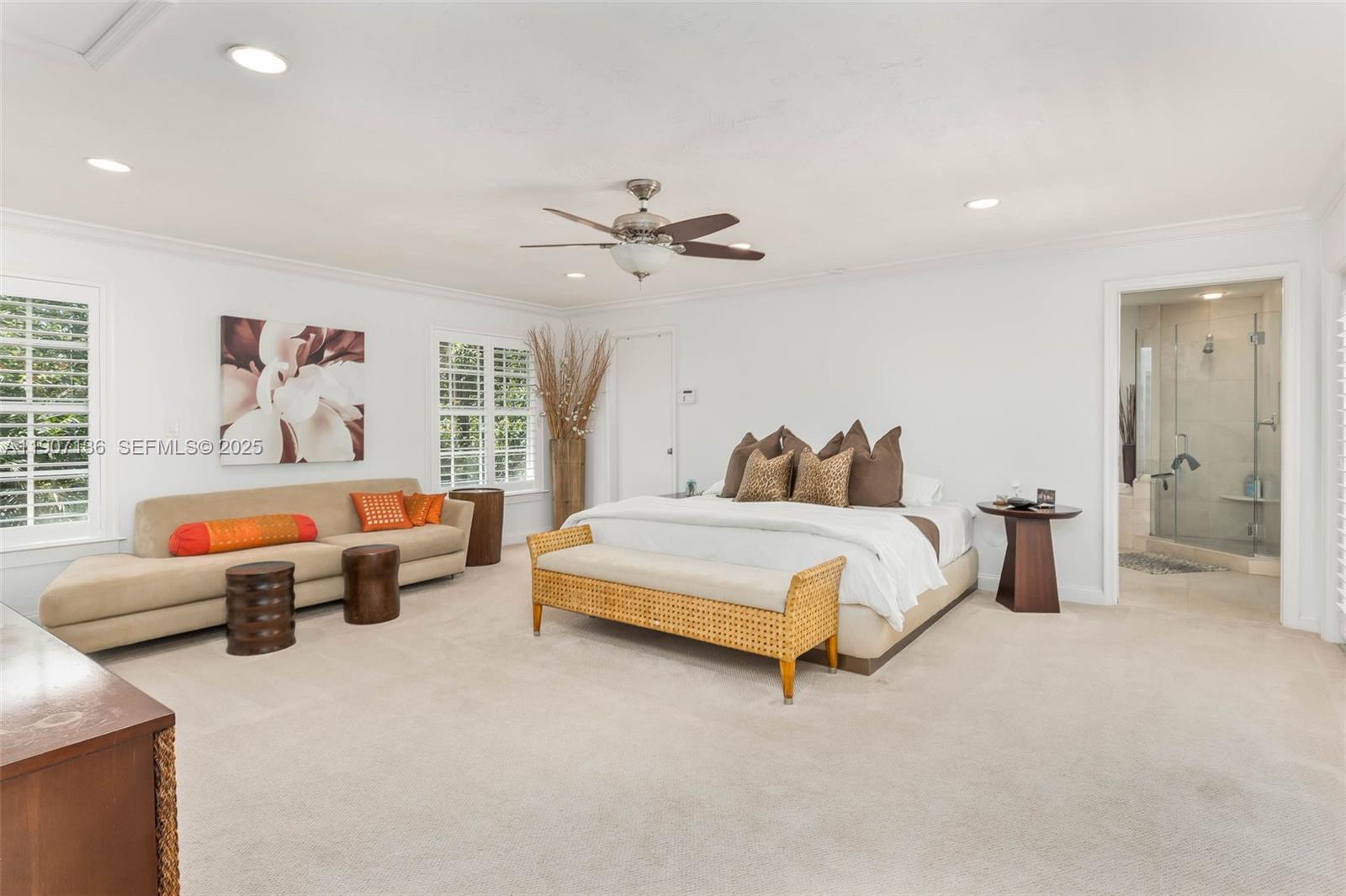 9240 Southwest 69th Court Pinecrest, FL 33156 - Photo 11 of 32 a bedroom with furniture and a chandelier