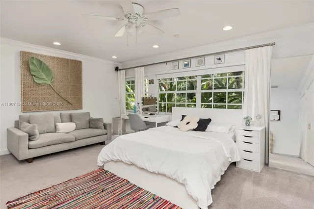 a bedroom with a large bed couch and a window