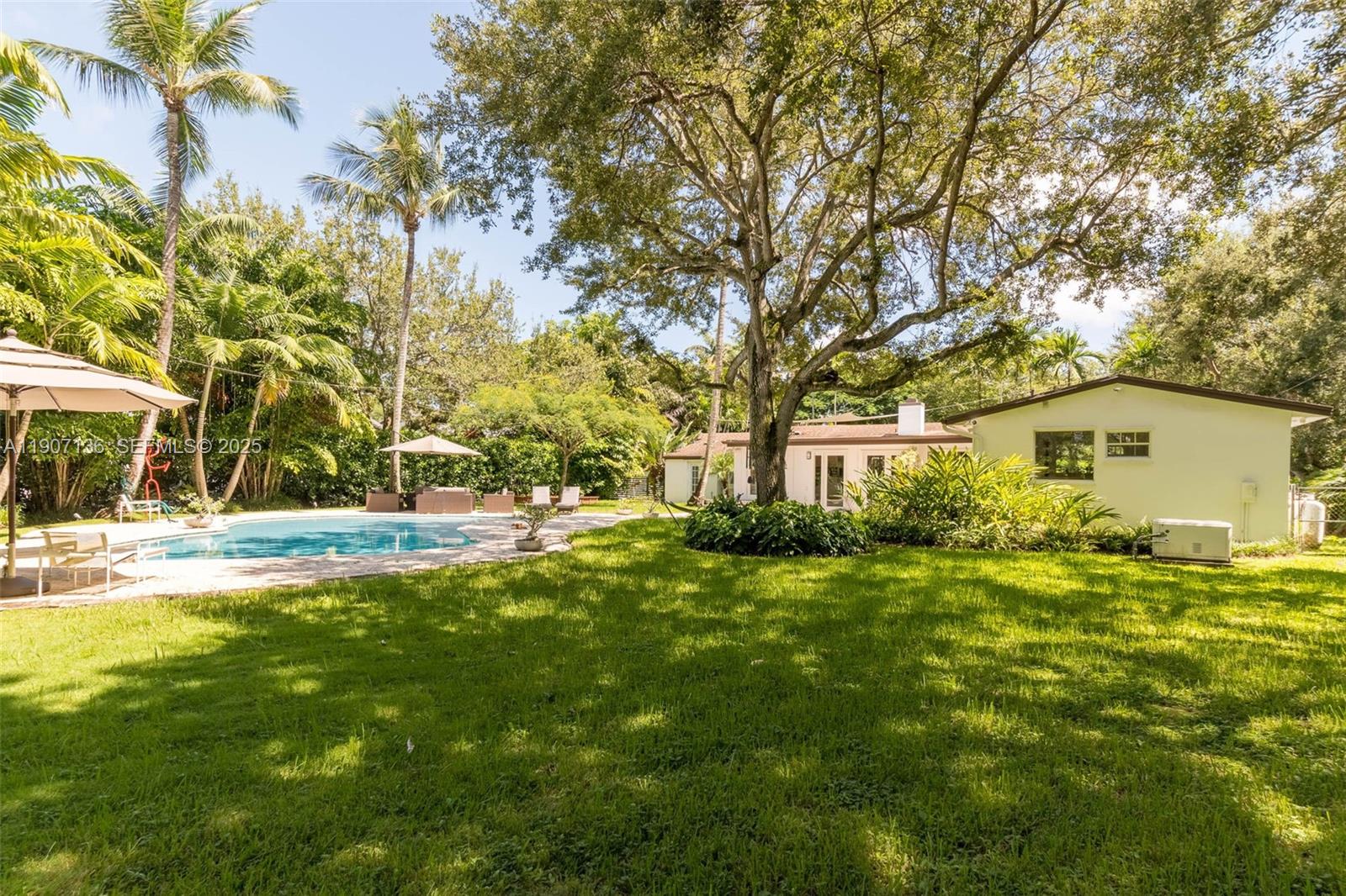 9240 Southwest 69th Court Pinecrest, FL 33156 - Photo 24 of 32 a view of backyard of house with green space