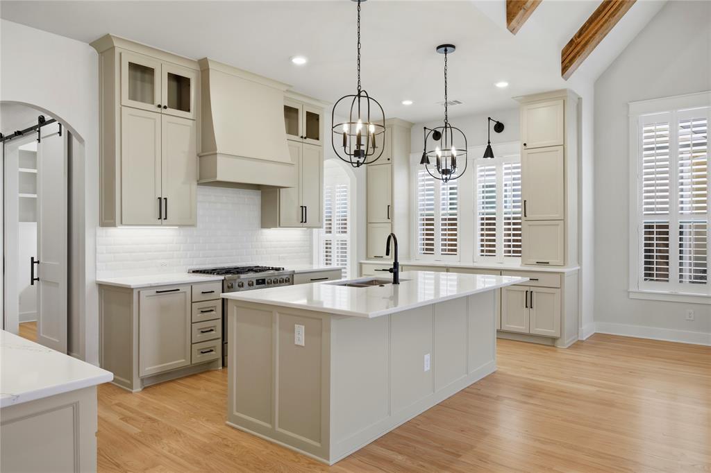 317 Dylan Way Midlothian, TX 76065 - Photo 18 of 20 a kitchen with stainless steel appliances granite countertop a stove a sink and a refrigerator