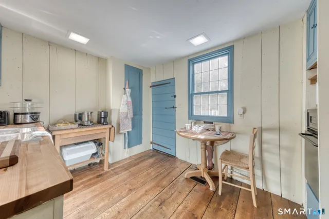 a view of a bedroom with furniture window and wooden floor